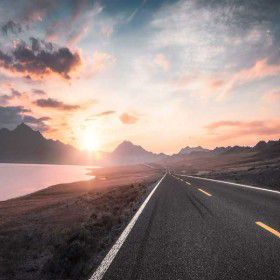 roadway with mountains and clouds in distance, Oracle | DXC Technology